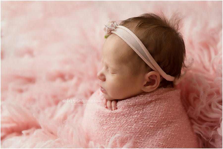 newborn girl wrapped in pink